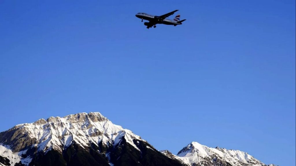 A British Airways plane flies low over the Alps on approach to Innsbruck airport.