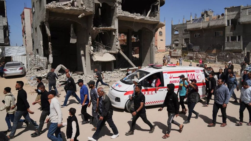 Mourners follow the convoy carrying the bodies of 8 Red Crescent emergency responders recovered in Rafah as they are transported for burial in Deir al-Balah, 31 March 2025