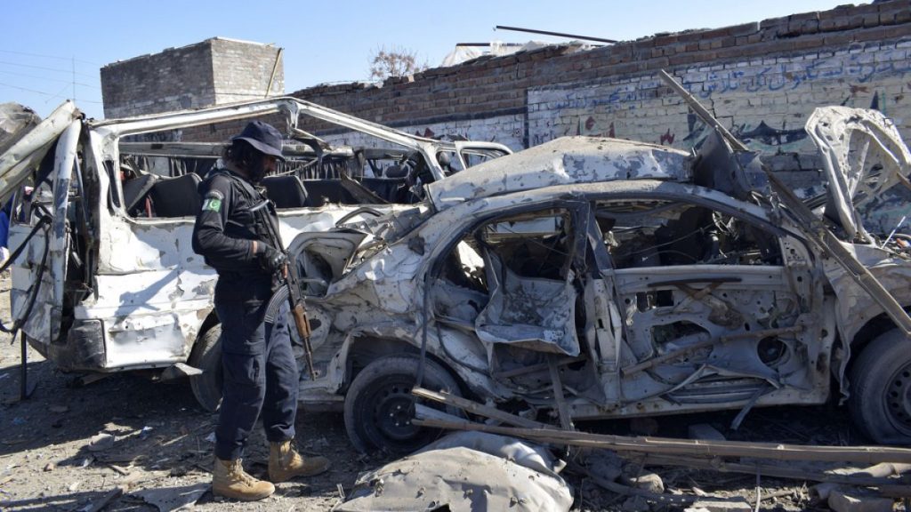 A police officer examines the damaged vehicles at the site of Tuesday