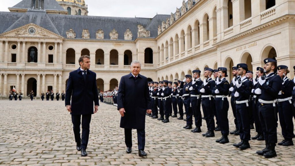 French President Emmanuel Macron and Uzbekistan President Shavkat Mirziyoyev review the troops during an official welcome ceremony in Paris Wednesday, March 12, 2025.