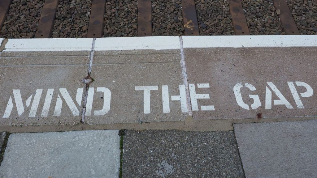 Mind the gap sign at transport station in London.