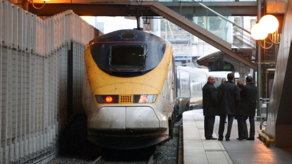 Eurostar employees chat on the platform, as a Eurostar train leaves the Gare du Nord station in Paris, Tuesday Dec. 22, 2009.