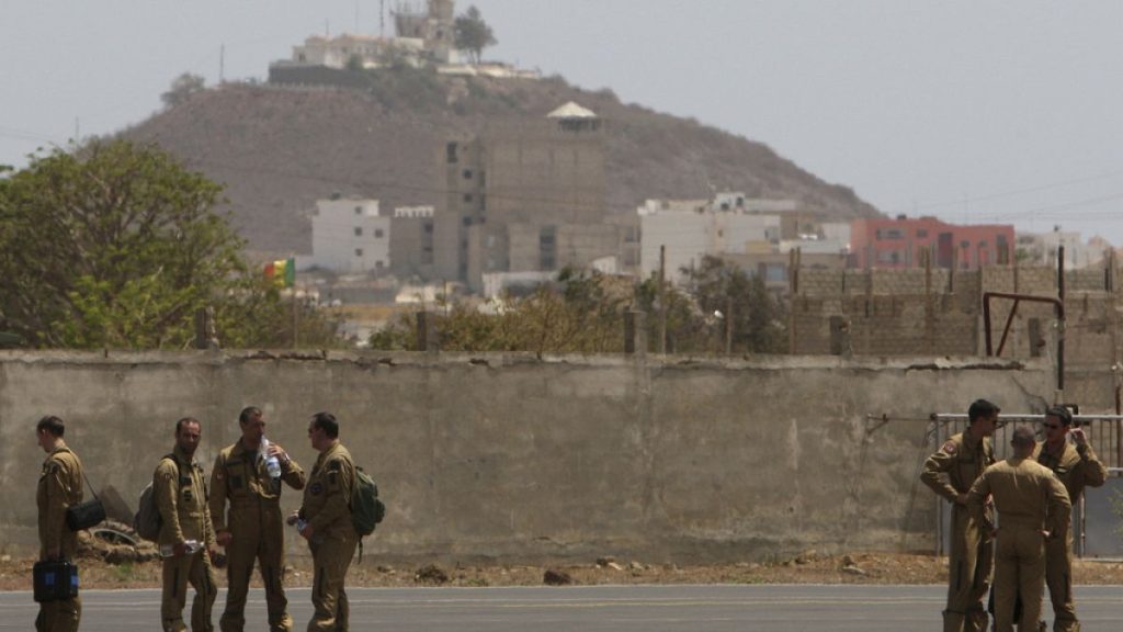 FILE - Members of a French military flight crew talk on the tarmac at France