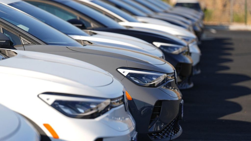 A long row of unsold 2024 electric ID4 utility vehicles are shown Sunday, July 28, 2024, at a Volkswagen dealership in Denver.