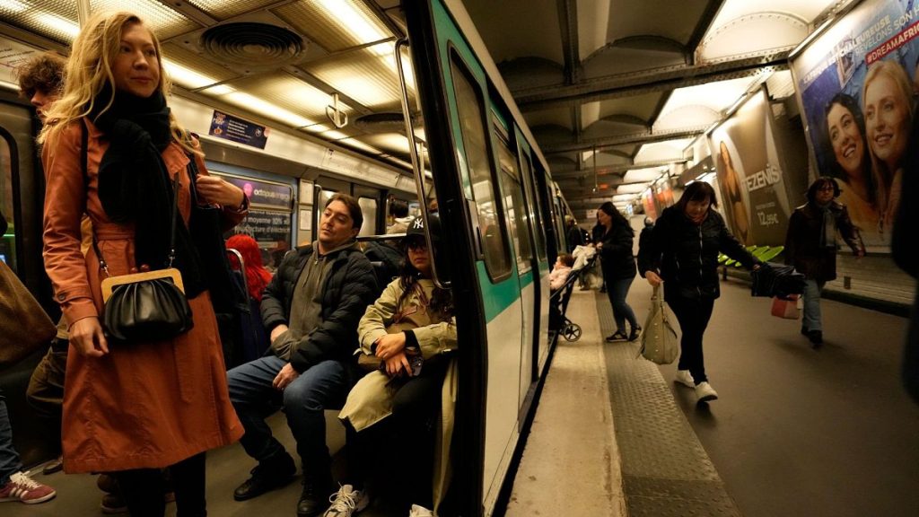 A passenger stands inside a metro train, at the Oberkampf district east of Paris, France, 26 October 2023.