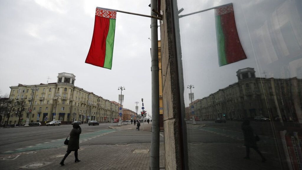 FILE: A Belarusian national flag flutters over a street in Minsk, Belarus, Wednesday, Feb. 16, 2022.
