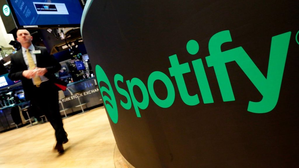 In this Tuesday, April 3, 2018 file photo, a trading post sports the Spotify logo on the floor of the New York Stock Exchange.