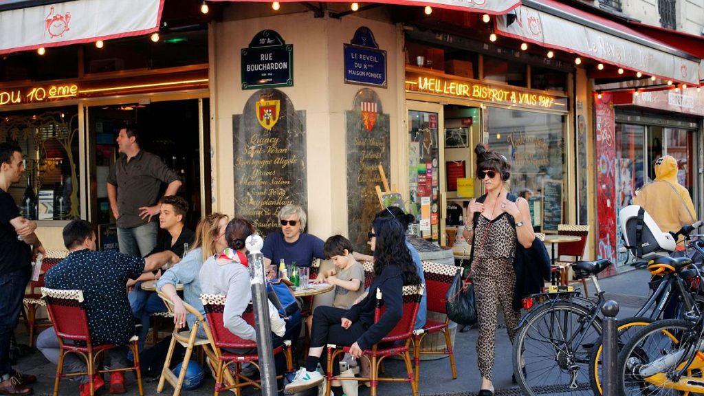 Parisians relax on a terrace at