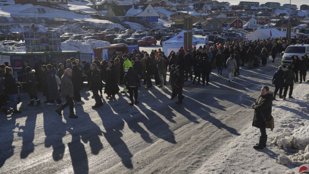 People stand in line outside a polling station to cast their vote in parliamentary elections, in Nuuk, Greenland, Tuesday, March 11, 2025.