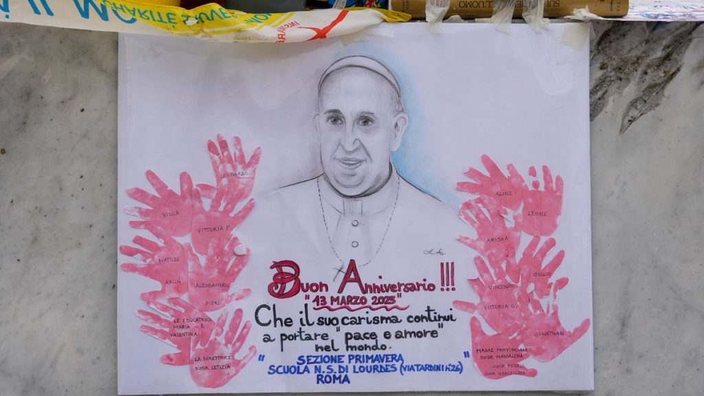 A poster depicting Pope Francis with the inscription