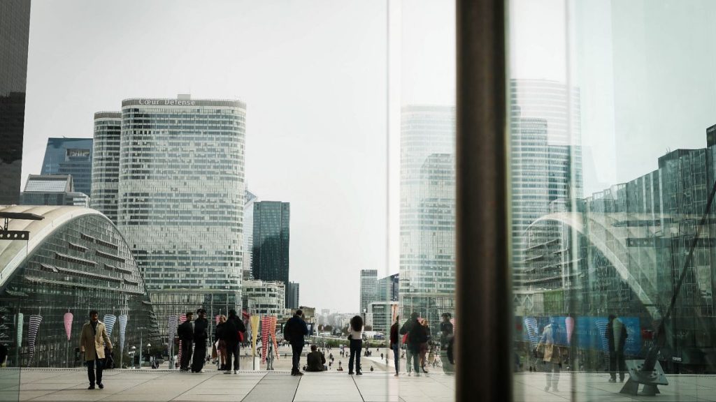 People stroll in La Defense business district outside Paris. 21 March 2025.