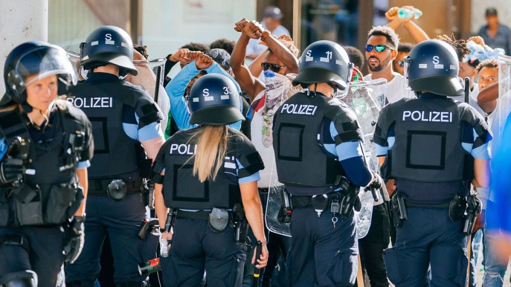 A group of people is surrounded by police forces after riots at an Eritrea event in Stuttgart, Germany, 16 September 2023.