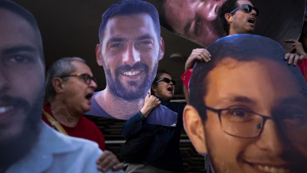 Demonstrators hold photos depicting the faces of Israeli hostages who are being held in the Gaza Strip, during a protest demanding their release from Hamas captivity.