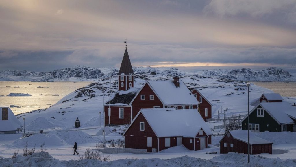 A woman walks near a church in Nuuk, Greenland, Friday, March 7, 2025.