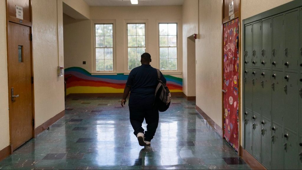 A teenager who had a bariatric surgery in 2022 walks along the hallway of his school in the US in March 2023.
