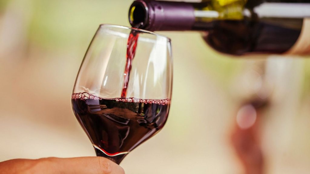 Red wine being poured into a glass