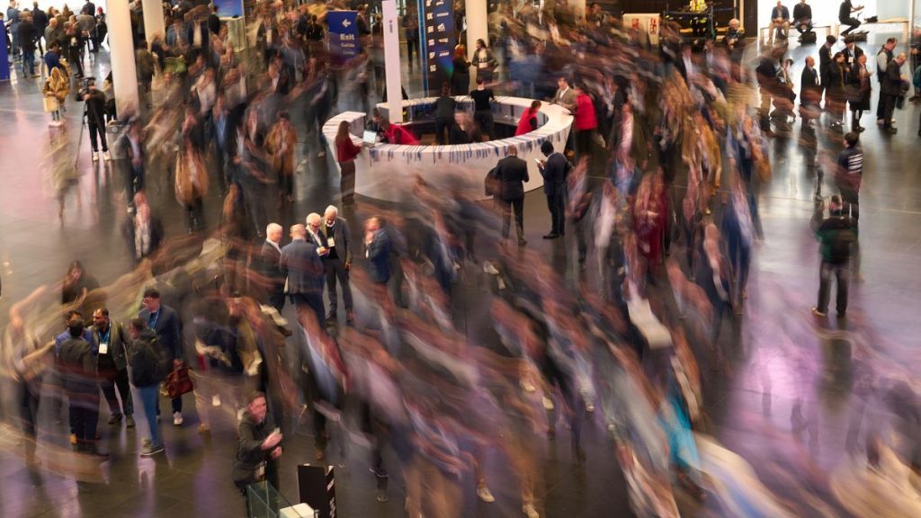 Visitors walk through the Mobile World Congress in Barcelona, Spain, Monday, March 3, 2025