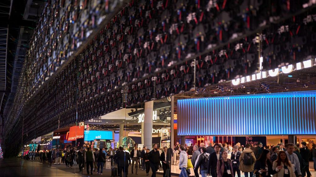 Attendees walk along the stands during the Mobile World Congress in Barcelona, Spain, Wednesday, March 5, 2025