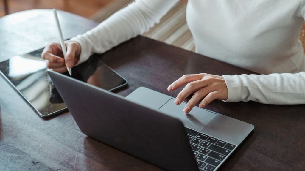 Faceless female entrepreneur multitasking.