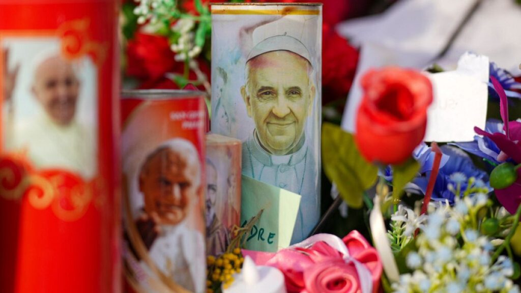 Candles and flowers for Pope Francis are seen in front of the Agostino Gemelli Polyclinic, in Rome, Sunday, March 2, 2025, where the Pontiff has been hospitalized since Friday