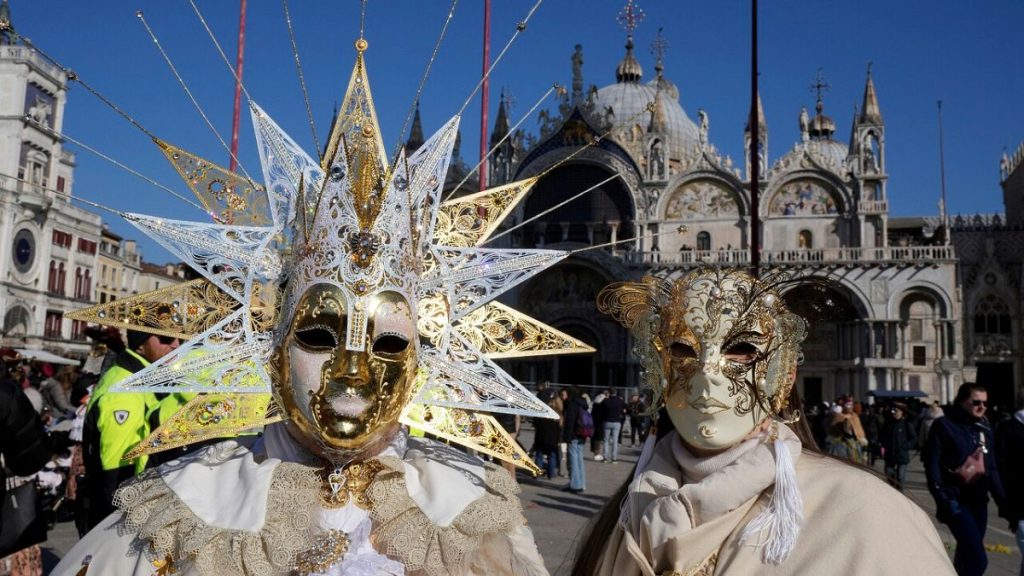 Revellers participate in the celebrations of the historic Venetian Carnival in front of St. Mark