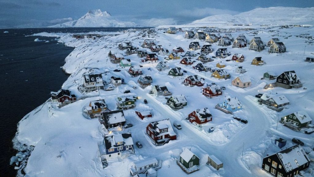 Houses covered by snow are seen on the coast of a sea inlet of Nuuk, Greenland, Friday, March 7, 2025.