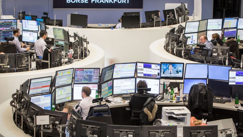 Traders look at their screens at the stock exchange in Frankfurt, Germany,