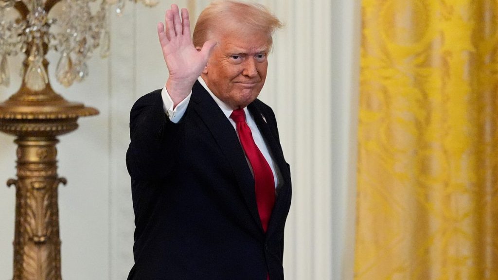 President Donald Trump waves after speaking at a reception celebrating Women