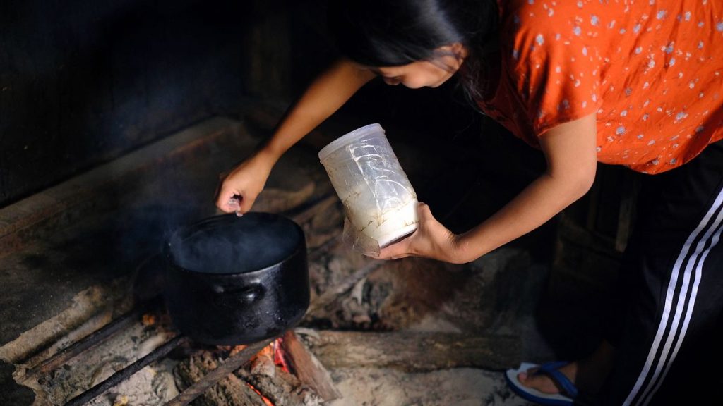 A woman cooks on an open fire in Kohima, India, on Thursday, Oct. 10, 2024.