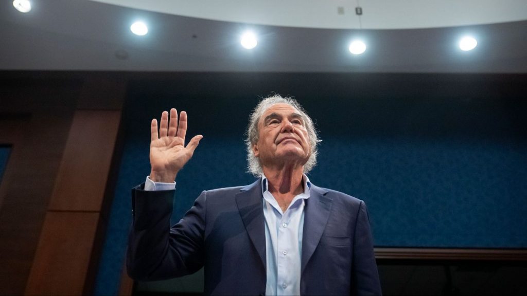 Director Oliver Stone stands to be sworn in during a hearing of the House Task Force on the Declassification of Federal Secrets on Capitol Hill