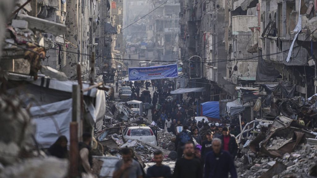 Palestinians walk through Al-Shati camp in Gaza City, 25 March, 2025