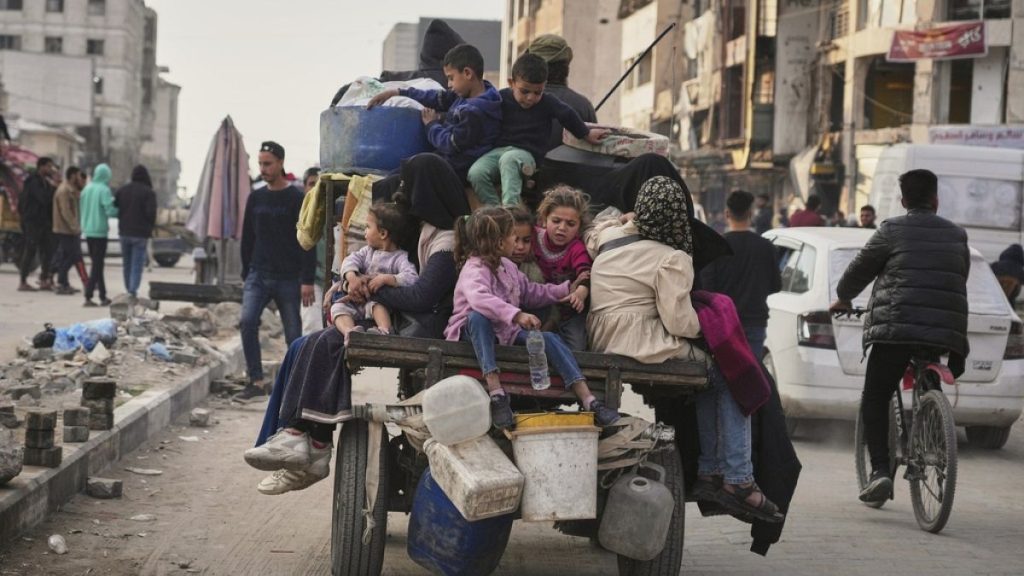 Displaced Palestinians flee from east to west of Gaza City after the Israeli military issued evacuation orders in the area, Friday April 11, 2025.
