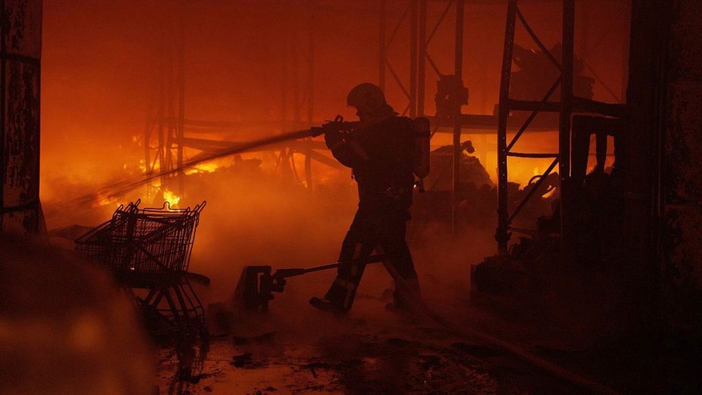 In this photo provided by the Ukrainian Emergency Service, emergency services personnel work to extinguish a fire following a Russian attack in Kyiv, Ukraine, April 12, 2025.