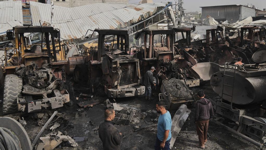 Palestinians examine the remains of bulldozers hit by an Israeli army airstrike in Jabaliya, 22 April, 2025