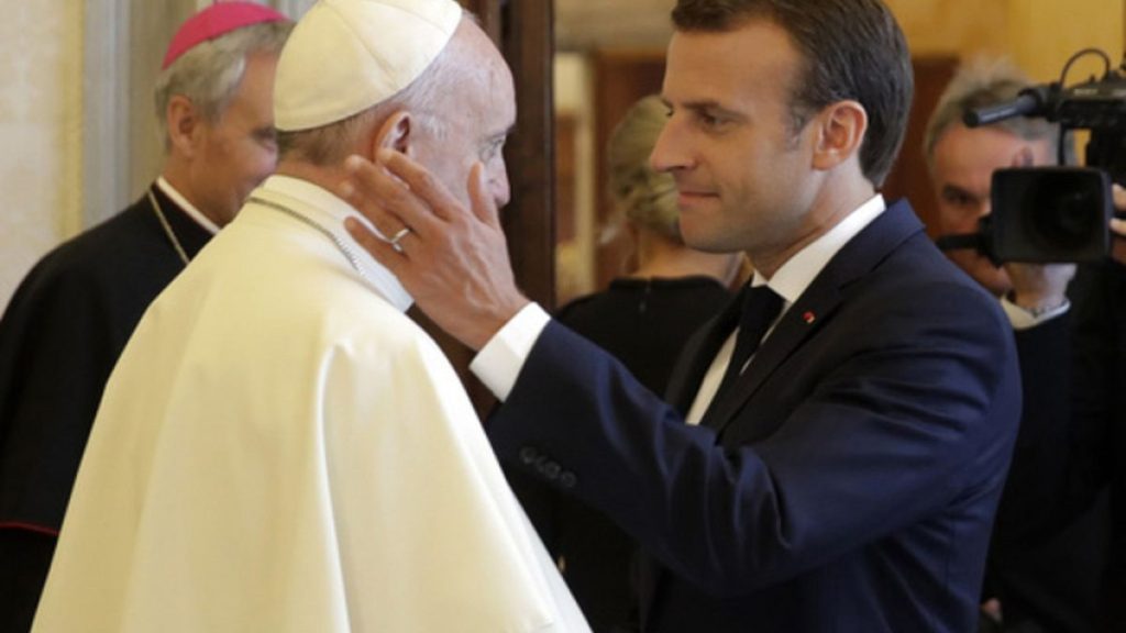 FILE - French President Emmanuel Macron, right, shakes hands with and goes to hug Pope Francis at the end of their private audience, at the Vatican, Tuesday, June 26, 2018.