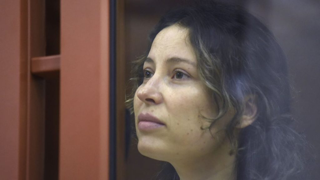 FILE: Ksenia Karelina sits in a glass cage in a court room in Yekaterinburg, 15 August 2024