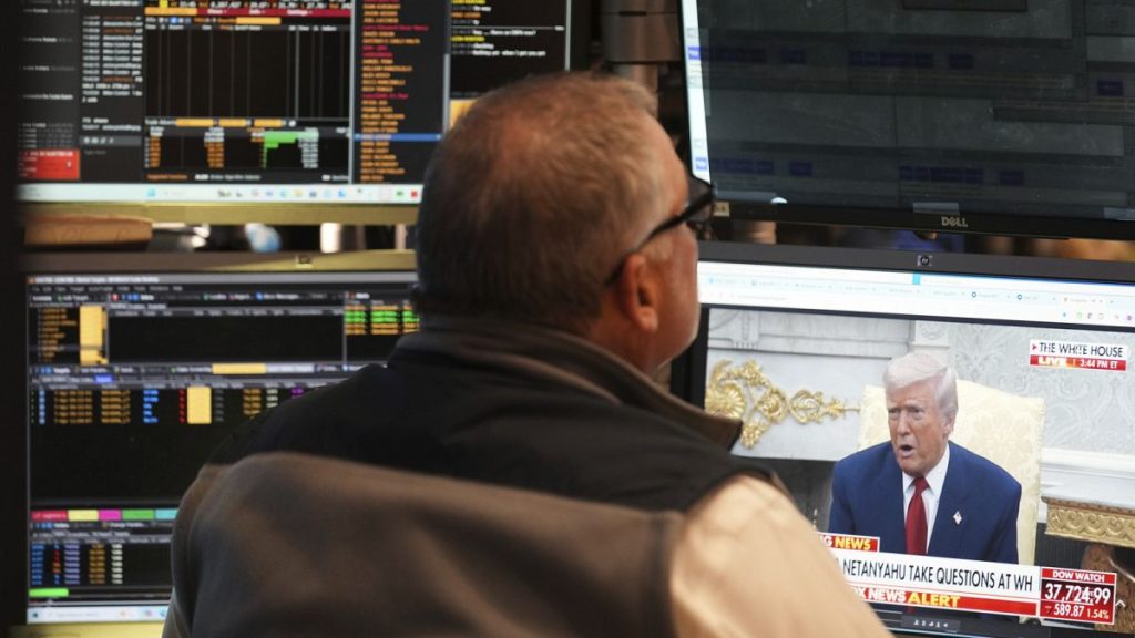 President Donald Trump is seen on the television as traders work on the floor at the New York Stock Exchange in New York, Monday, April 7, 2025.