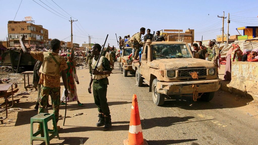Soldiers arrive to the Allafah market, in an area recently recaptured by Sudan