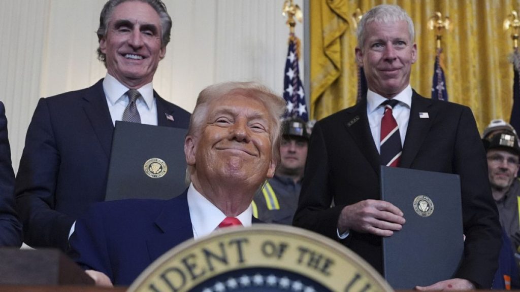 US Energy Secretary Chris Wright (R) and Interior Secretary Doug Burgum stands by as president Donald Trump signs his latest executive orders on 8 April 2025.