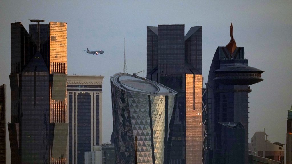 FILE: An aircraft flying near skyscrapers of West Bay, approaches the Hamad International Airport in Doha, 25 January 2024