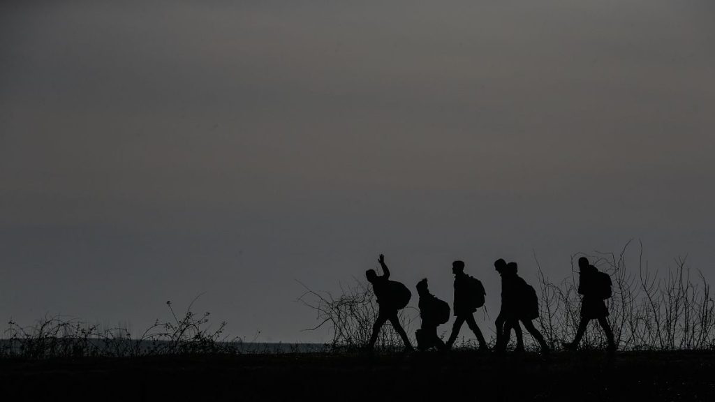 Migrants walk to enter Greece from Turkey by crossing the Maritsa River, 1 March, 2020