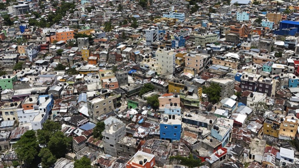 FILE: Homes cover a hill in the La Zurza neighborhood of Santo Domingo, Dominican Republic, Saturday, May 18, 2024