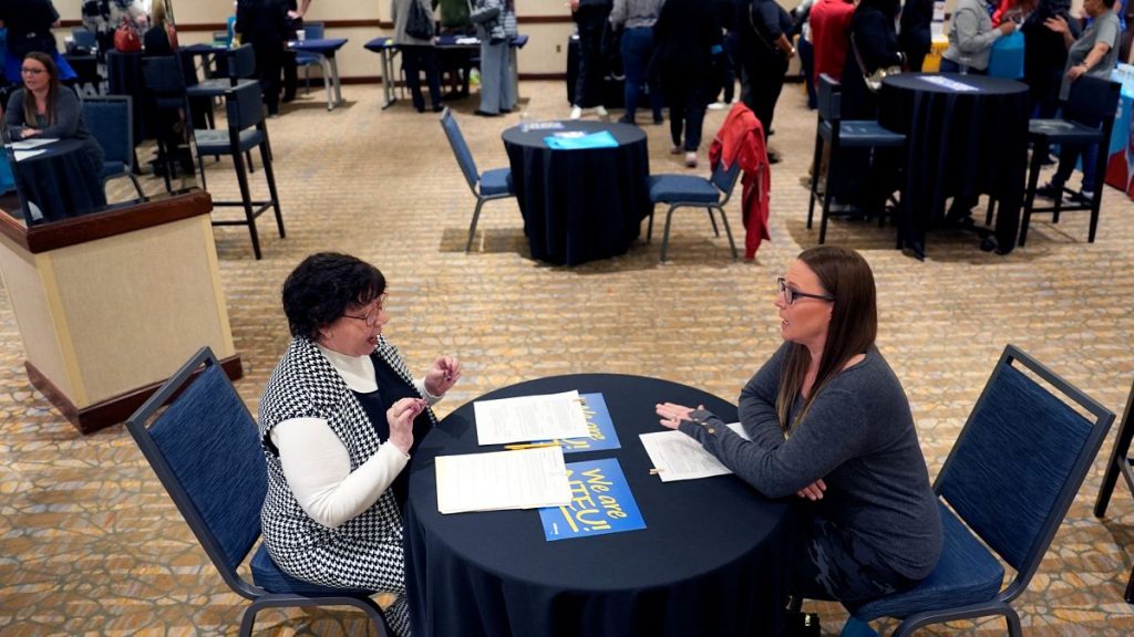 Fired IRS worker Brittany Glenn, right, talks to recruiter Lena Lager during a jobs fair for laid-off federal workers Saturday, March 15, 2025, in Kansas City, Mo.