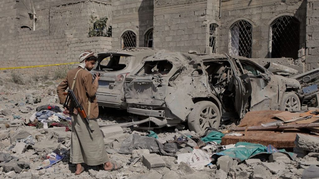 FILE: A Houthi rebel inspects the damage reportedly caused by U.S. airstrikes in Sanaa, 7 April 2025