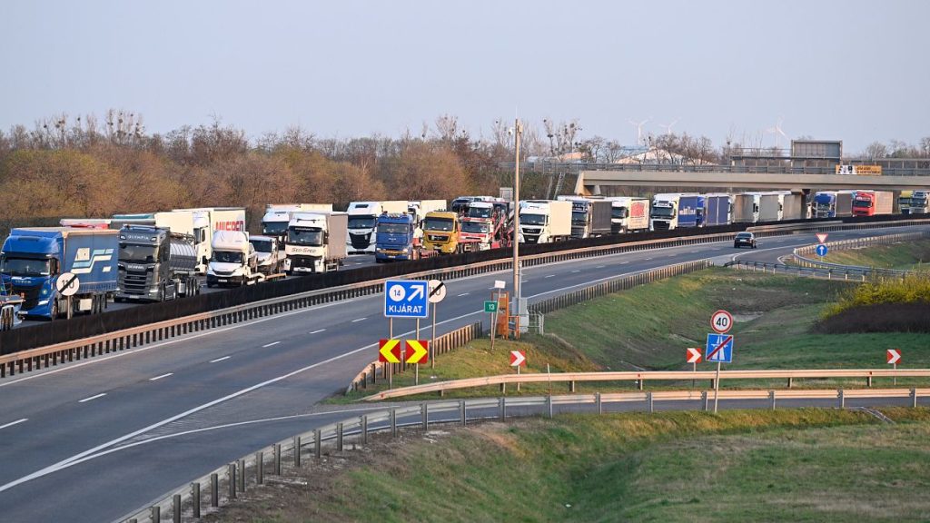 Trucks queue on the road leading to the border crossing between Hungary and Slovakia at Rajka, 27 March, 2025