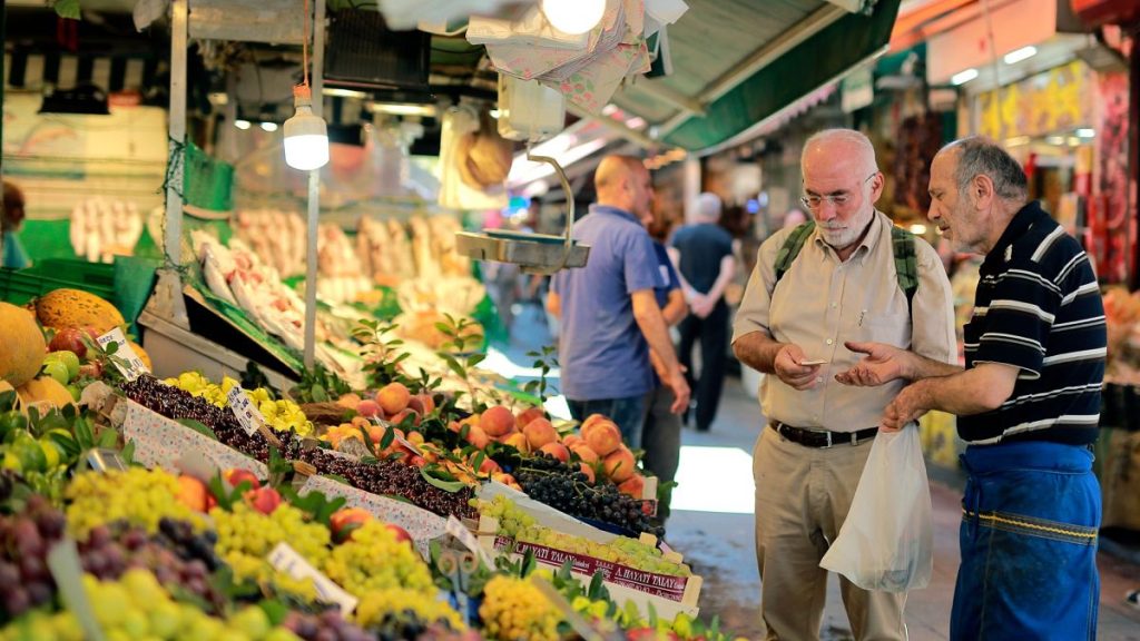 A man shops in a market in Istanbul, Monday, Aug. 13, 2018.