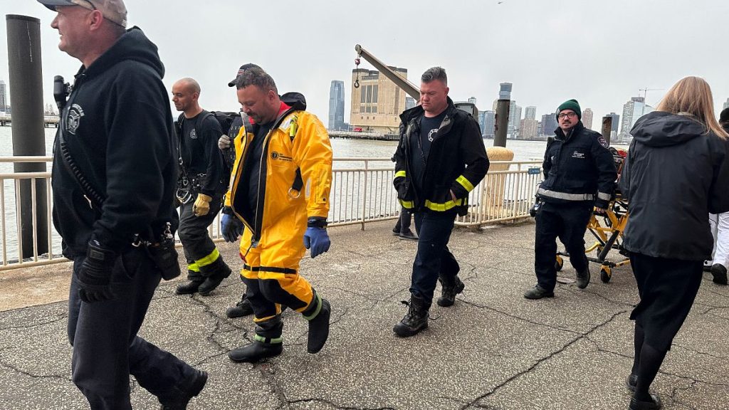 First responders walk along Pier 40 in New York across from where a helicopter went down in the Hudson River between Manhattan, New Jersey waterfront, Thursday, April 10, 2025