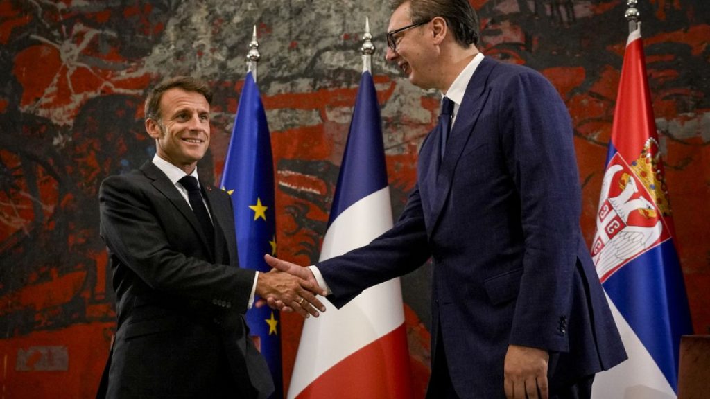FILE - French President Emmanuel Macron, left, shakes hands with Serbian President Aleksandar Vucic in Belgrade, Serbia, Thursday, Aug. 29, 2024.