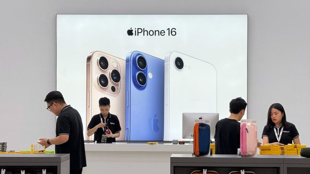 Sales staffs work at an Apple shop in Hanoi, Vietnam on Thursday, April 10, 2025.