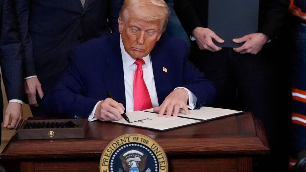 President Donald Trump signs an executive order during an event in the East Room of the White House, Tuesday, April 8, 2025, in Washington.